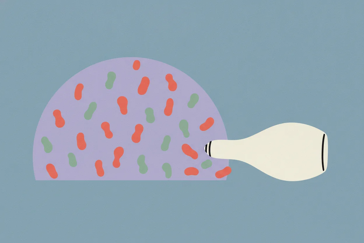 Illustration of a lilac patch of skin dotted with coral and green blobs, with a tipped cream bottle nudging a few blobs off the edge